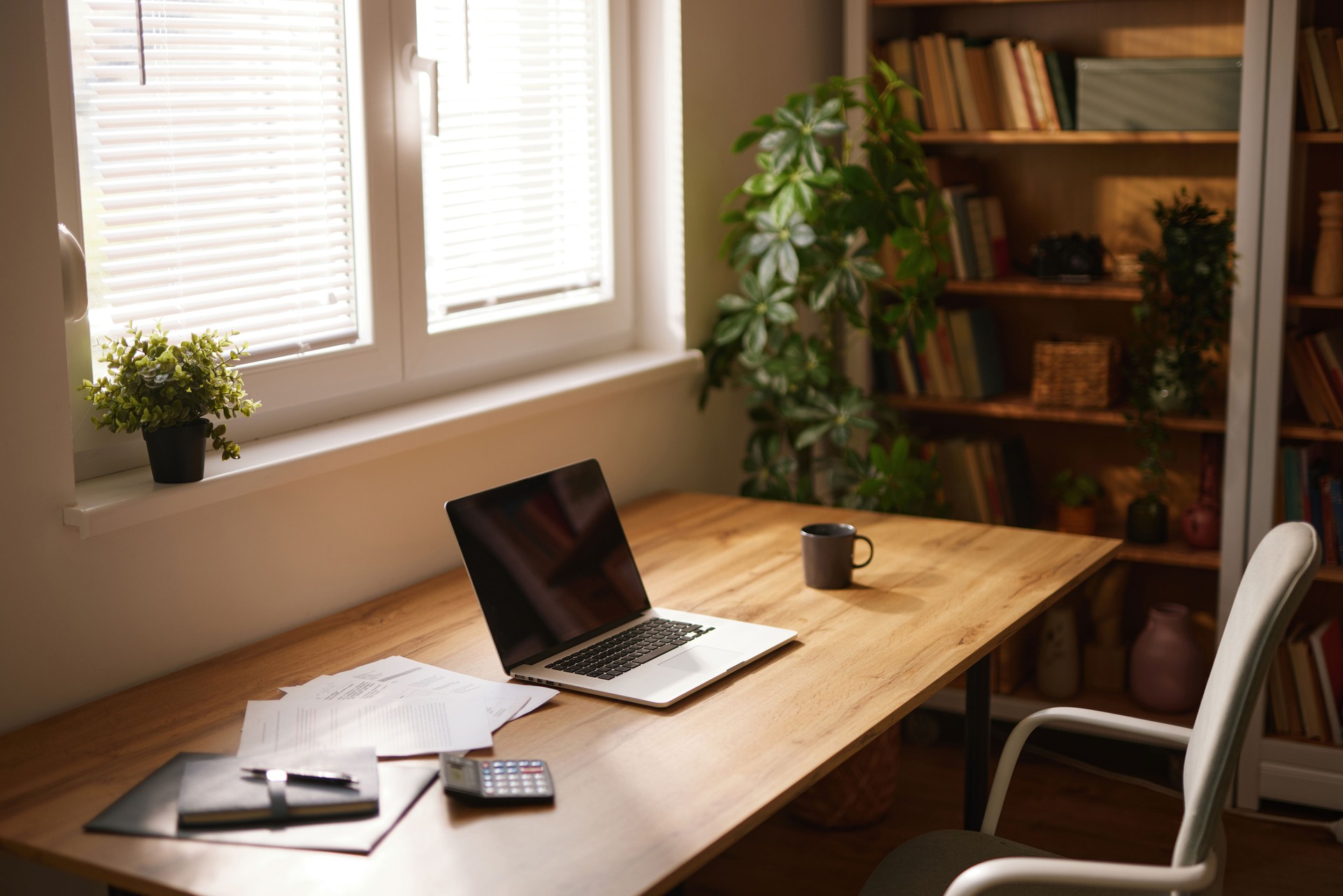 Comfortable home office setup with laptop and documents on desk